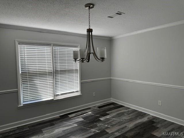 unfurnished dining area with plenty of natural light, an inviting chandelier, and a textured ceiling