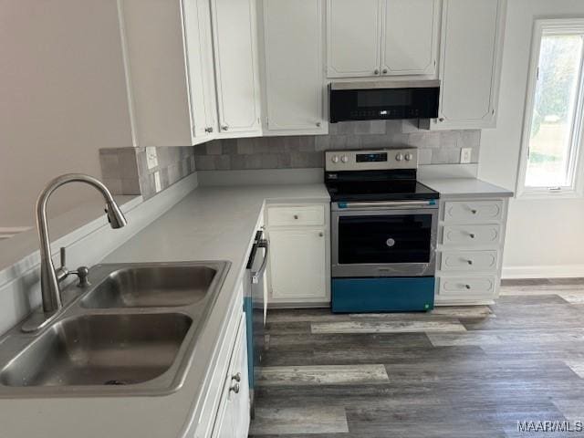 kitchen featuring white cabinetry, dark hardwood / wood-style flooring, stainless steel appliances, tasteful backsplash, and sink