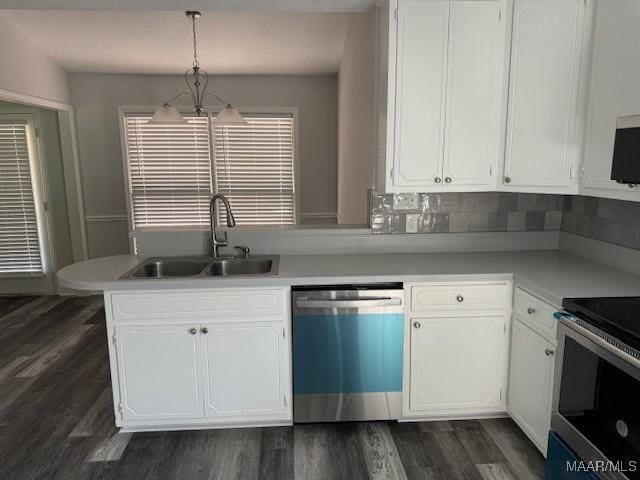 kitchen featuring stainless steel appliances, sink, white cabinetry, and decorative light fixtures