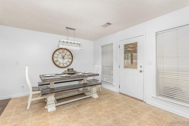 dining area featuring a textured ceiling