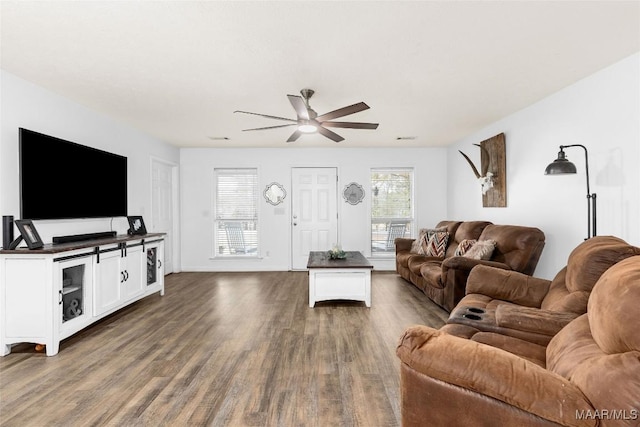 living room with ceiling fan and dark hardwood / wood-style floors