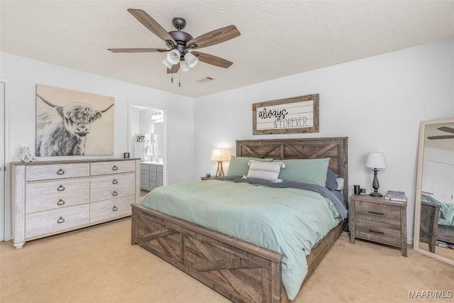 carpeted bedroom with a textured ceiling, ceiling fan, and ensuite bathroom