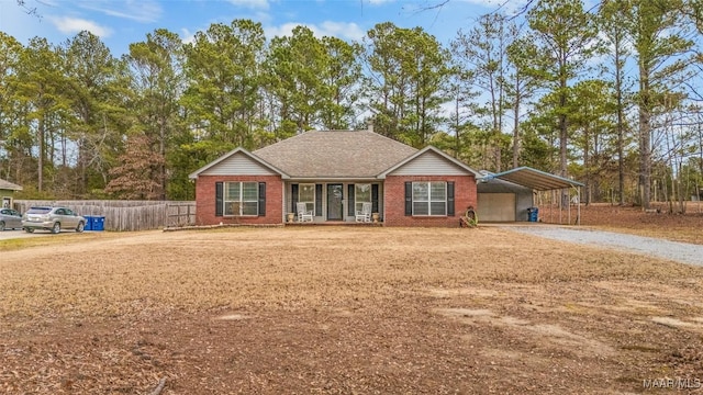 ranch-style home featuring a front yard and a carport