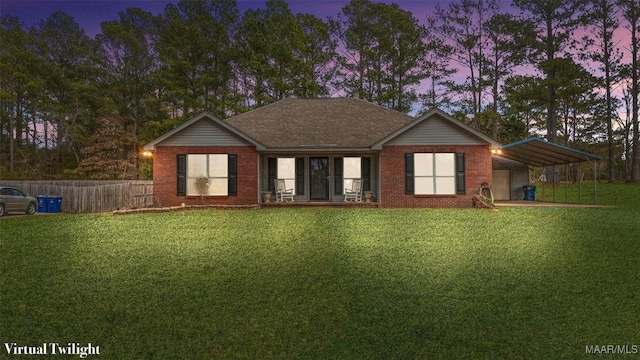 view of front facade featuring a carport and a lawn