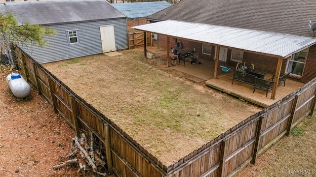 view of yard featuring a wooden deck and an outbuilding