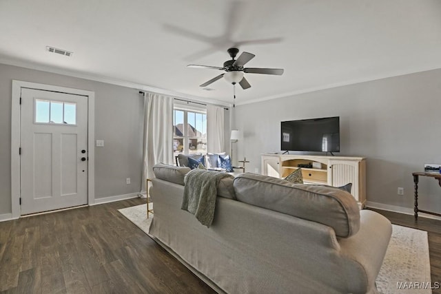 living room featuring ceiling fan, dark hardwood / wood-style flooring, and ornamental molding