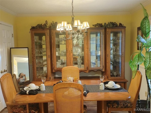 dining room featuring a notable chandelier and crown molding