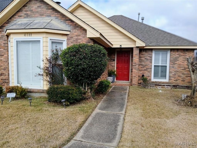 bungalow-style home with a front lawn