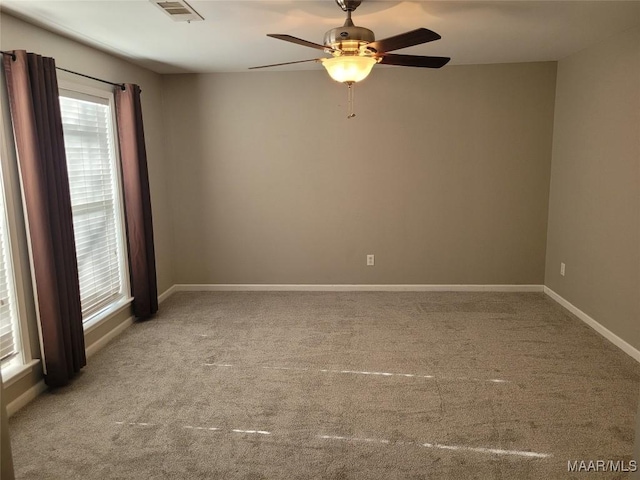 carpeted spare room with ceiling fan