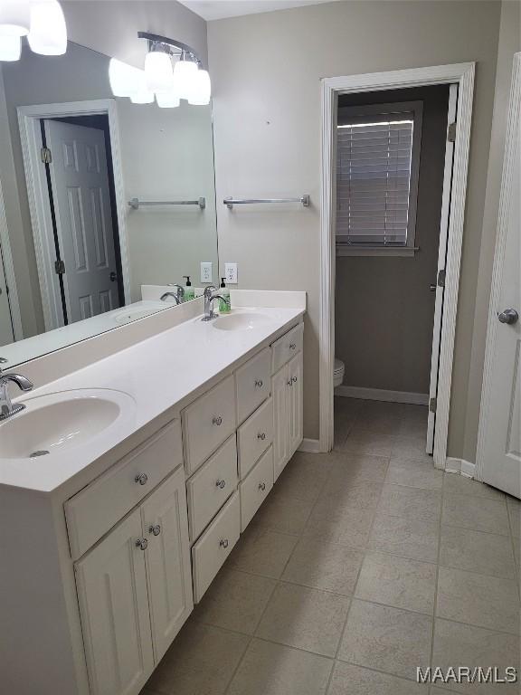 bathroom featuring toilet and vanity