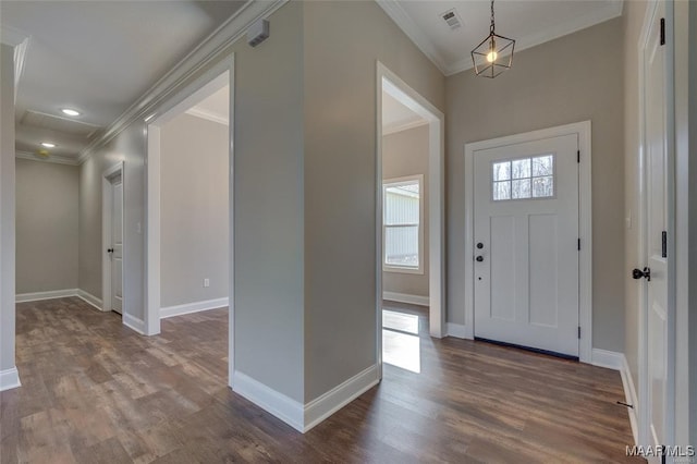 foyer with hardwood / wood-style flooring and ornamental molding