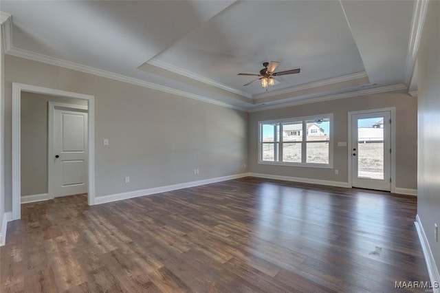 unfurnished room featuring crown molding, ceiling fan, a tray ceiling, and dark hardwood / wood-style flooring