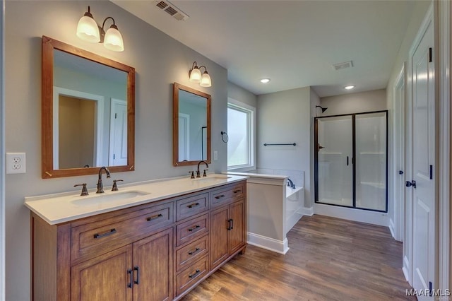 bathroom featuring vanity, separate shower and tub, and wood-type flooring