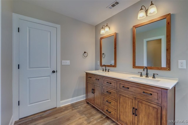 bathroom with vanity and hardwood / wood-style floors