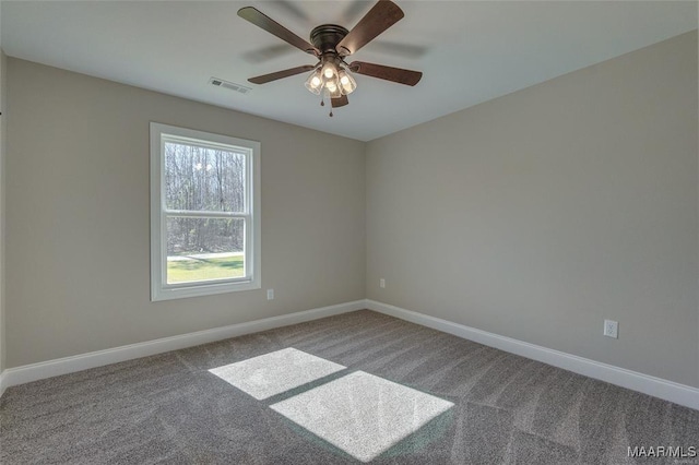 spare room featuring ceiling fan and carpet