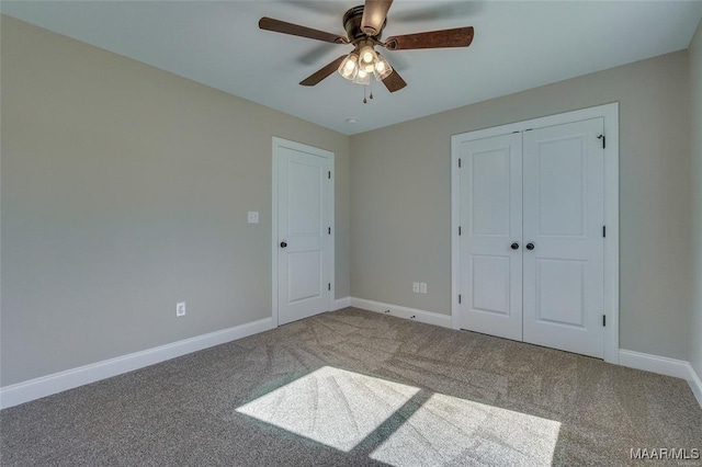 unfurnished bedroom with carpet floors, ceiling fan, and a closet