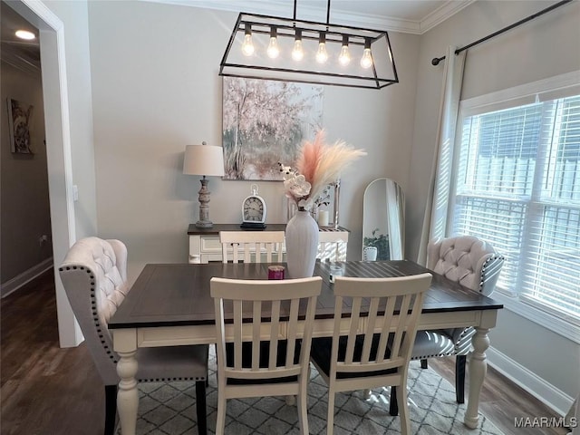 dining space featuring ornamental molding and dark hardwood / wood-style floors