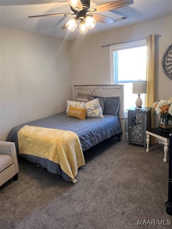 carpeted bedroom with ceiling fan