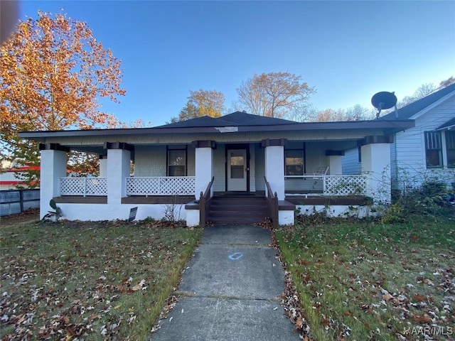 view of front facade featuring covered porch and a front yard