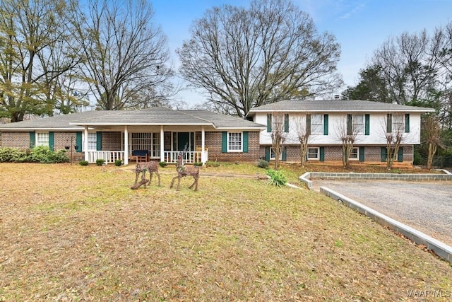 view of front of house with a front yard and a porch