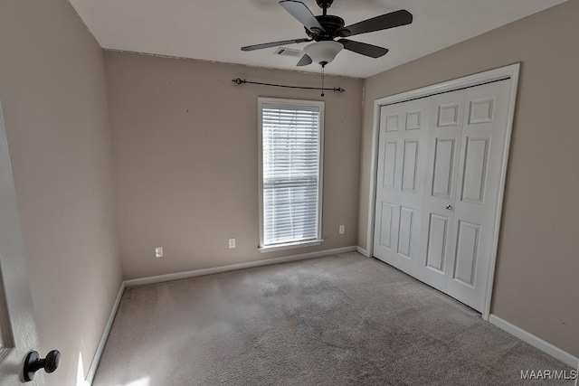 unfurnished bedroom with ceiling fan, light colored carpet, and a closet