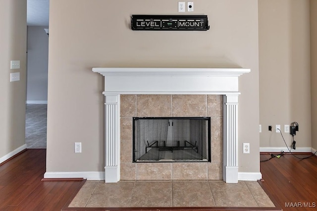 details with hardwood / wood-style floors and a fireplace