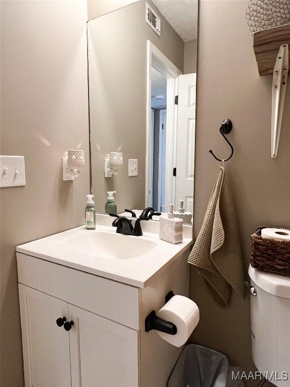 bathroom featuring toilet and vanity