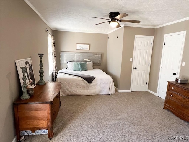 bedroom featuring ceiling fan, ornamental molding, a textured ceiling, and carpet flooring