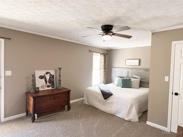 bedroom with ceiling fan, a textured ceiling, carpet floors, and crown molding