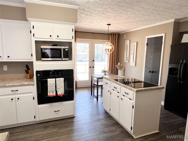 kitchen featuring an inviting chandelier, french doors, hanging light fixtures, white cabinets, and black appliances