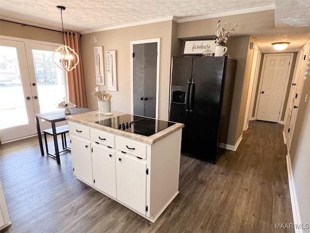 kitchen with pendant lighting, black appliances, white cabinetry, a textured ceiling, and french doors