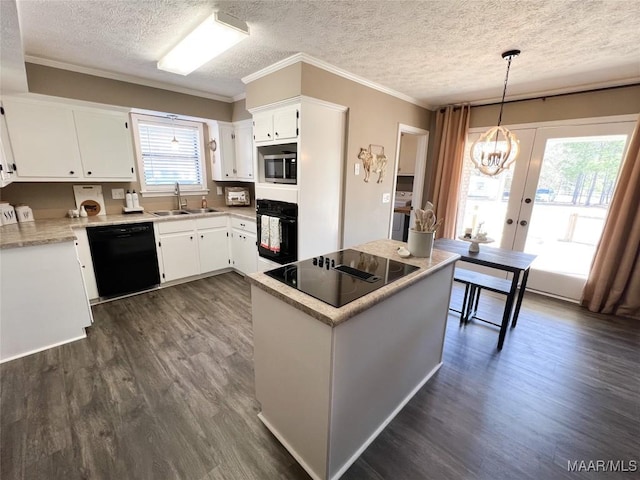 kitchen featuring french doors, pendant lighting, white cabinets, and black appliances