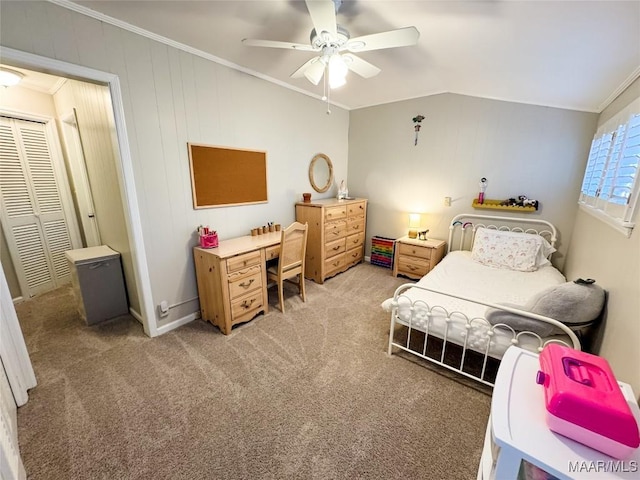 carpeted bedroom featuring ceiling fan, lofted ceiling, a closet, and ornamental molding