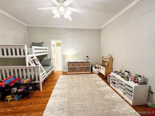 bedroom featuring ceiling fan, wood-type flooring, and ornamental molding