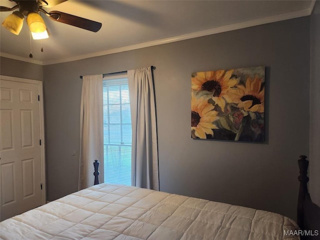 bedroom featuring ceiling fan and crown molding