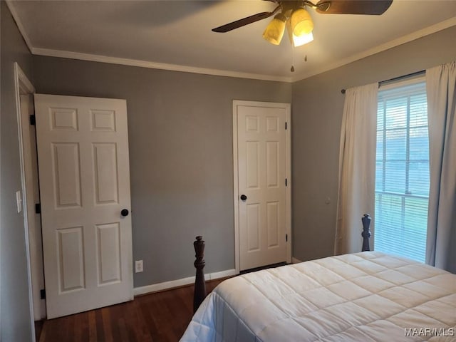 bedroom featuring ceiling fan, dark hardwood / wood-style flooring, and crown molding