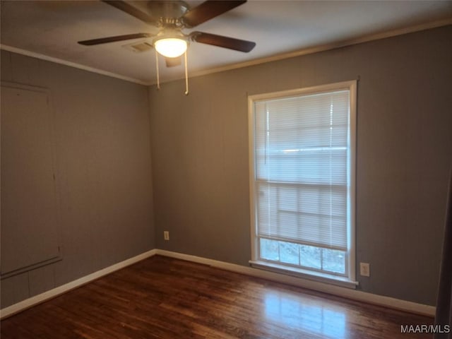 spare room featuring ceiling fan, ornamental molding, and dark hardwood / wood-style floors