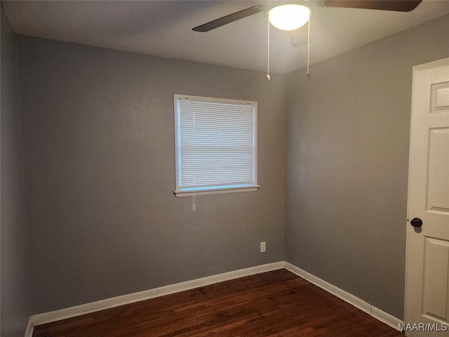 unfurnished room with ceiling fan and dark hardwood / wood-style flooring