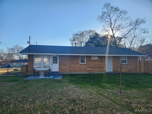 rear view of property with a patio area and a yard