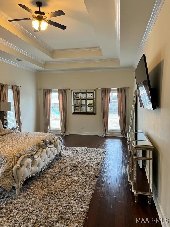 bedroom featuring ceiling fan, a tray ceiling, and crown molding