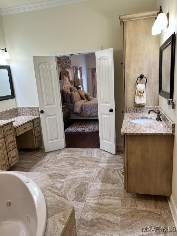 bathroom featuring crown molding, a tub to relax in, and vanity