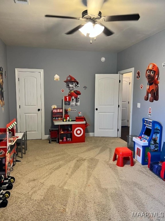 playroom with ceiling fan and carpet