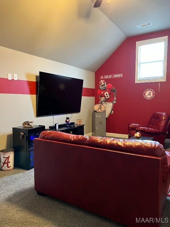 living room featuring carpet floors, ceiling fan, and vaulted ceiling