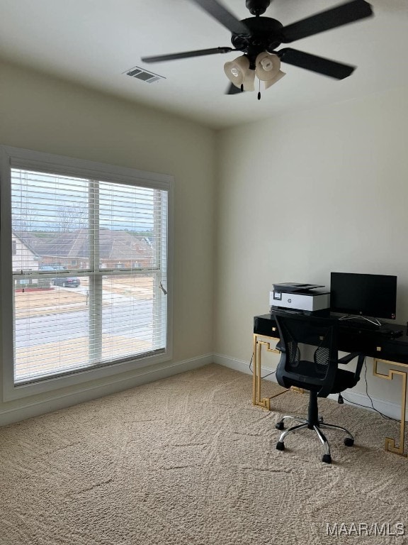 carpeted office featuring ceiling fan and plenty of natural light