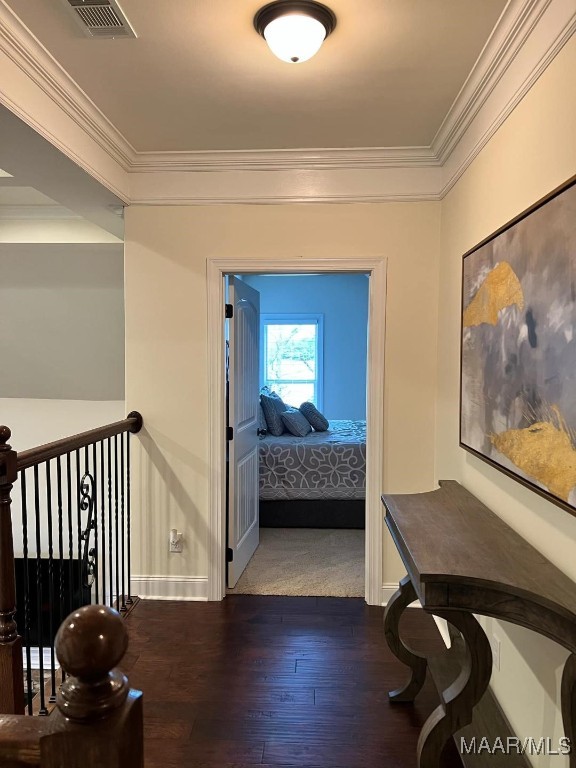 hall with dark hardwood / wood-style flooring and crown molding