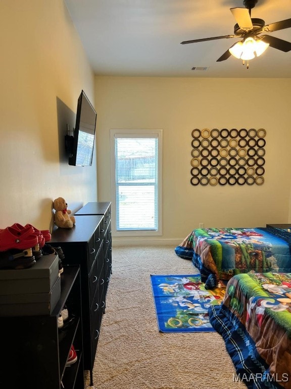 bedroom with ceiling fan and light carpet