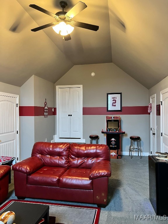 living room featuring vaulted ceiling, ceiling fan, and carpet