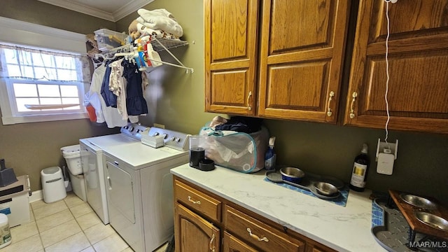 137 Scott Ln, Prattville, AL 36066 - laundry area featuring washer and clothes dryer, cabinet space, ornamental molding, and light tile patterned floors