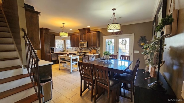 137 Scott Ln, Prattville, AL 36066 - dining space featuring stairway, french doors, light tile patterned flooring, crown molding, and recessed lighting