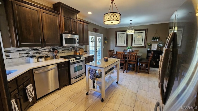 137 Scott Ln, Prattville, AL 36066 - kitchen featuring appliances with stainless steel finishes, french doors, tasteful backsplash, light countertops, and dark brown cabinets